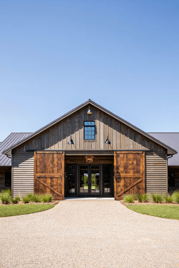 sliding barn doors for the main entry on a Farmhouse Barndominium Idea