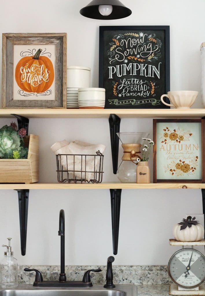 Autumnal art prints on open shelves