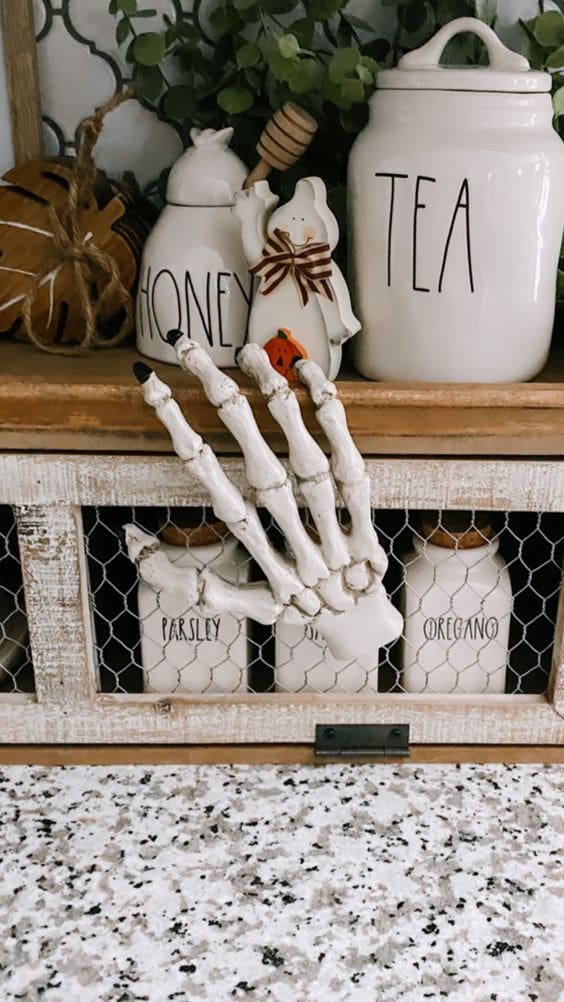 white skeleton hand on a kitchen cabinet