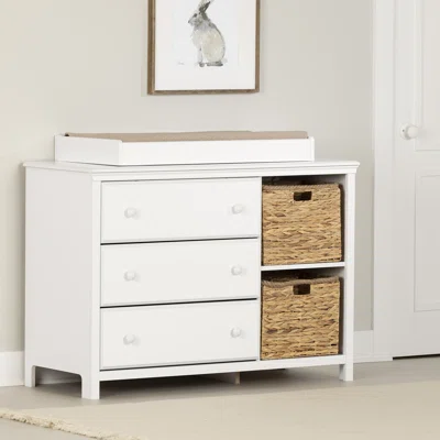 white changing table with rattan baskets