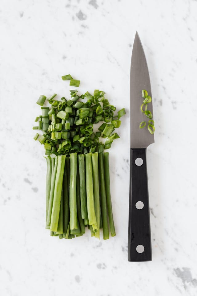 Scallions on a white cutting board are a winter vegetable 