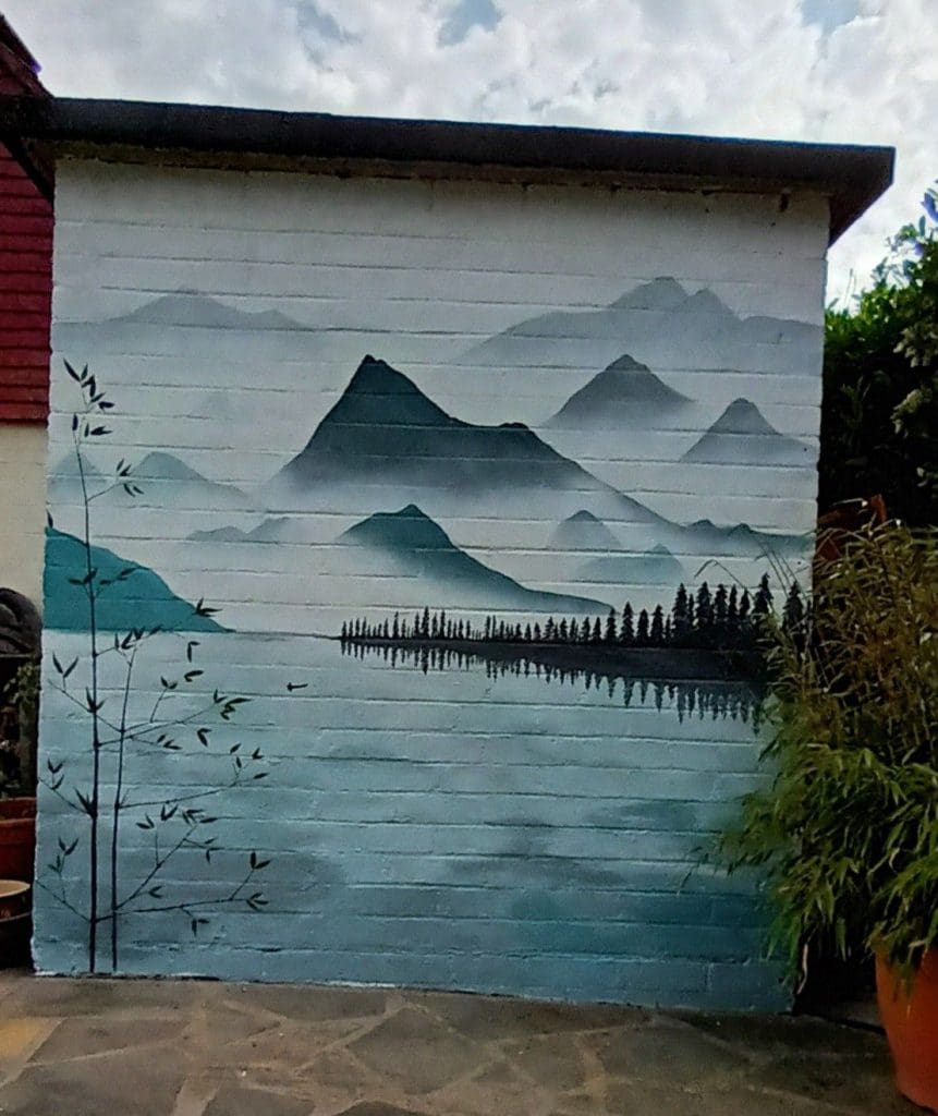 a hazy mountain mural with a lake and outlines of mountains