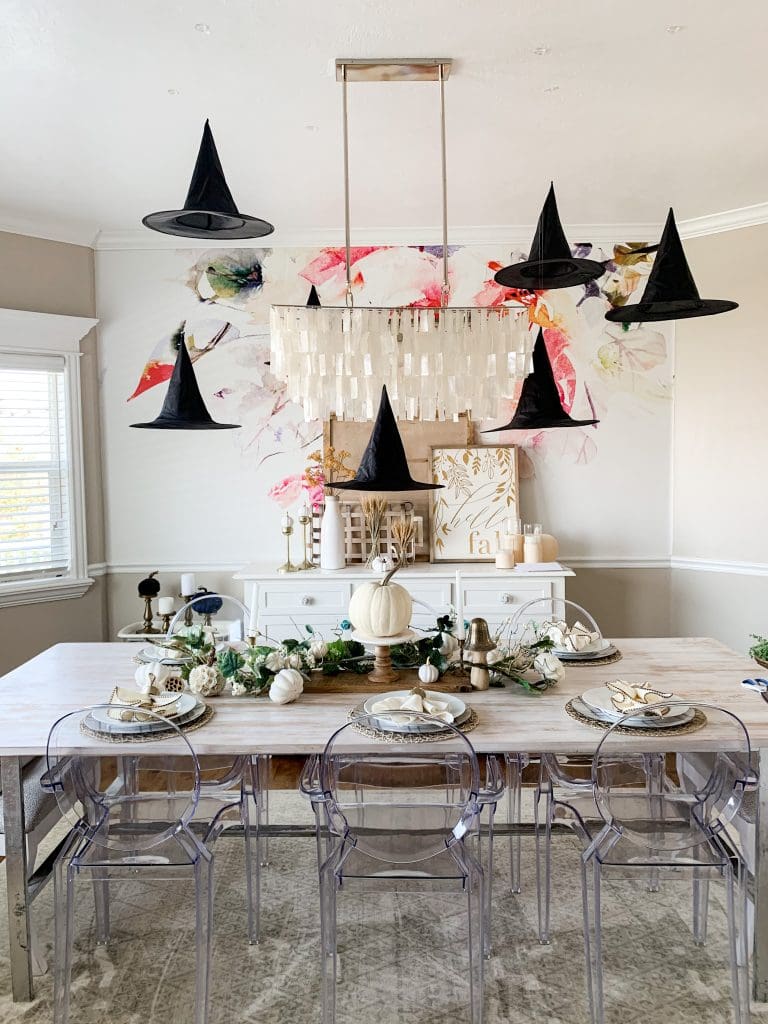 Black witches hat on ceiling of a kitchen that look likle they are floating