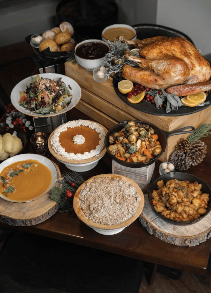 Thanksgiving food on a rustic brown table waiting to be served 