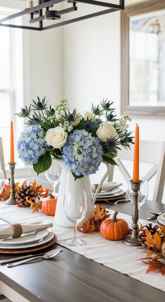 white pitcher with blue hydrangeas and white roses on a thanksgiving table