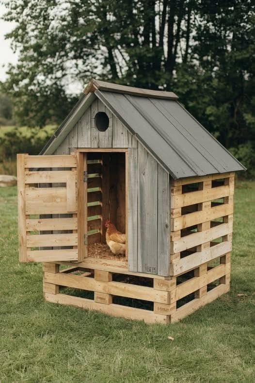 a chicken nest made from old pallets in a garden 