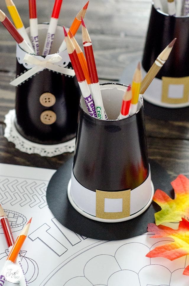 Pilgrim hats made from black soda cups decorated and holding pencils