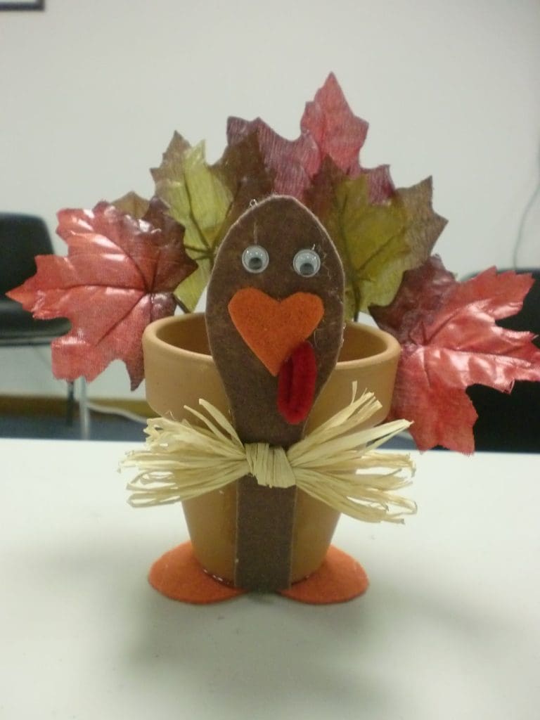 Office Thanksgiving themed pen holder made from a ceramic pot and decorated like a turkey