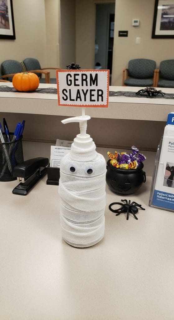 Hand sanitiser bottle wrapped in white material with googly eyes stuck on
