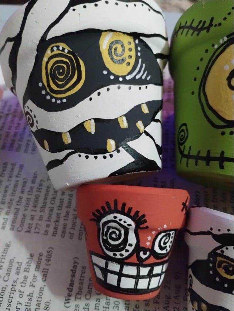 Last Minute Inside Halloween Decor of plant pots with spooky monster faces pianted on