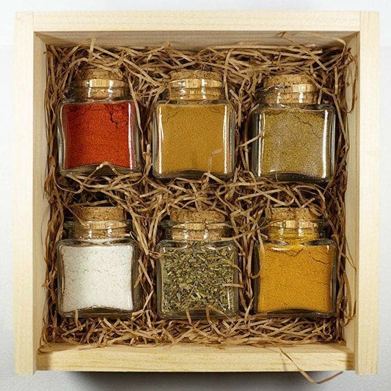 box filled with mini jars of festive spices Thanksgiving Gift Basket  idea