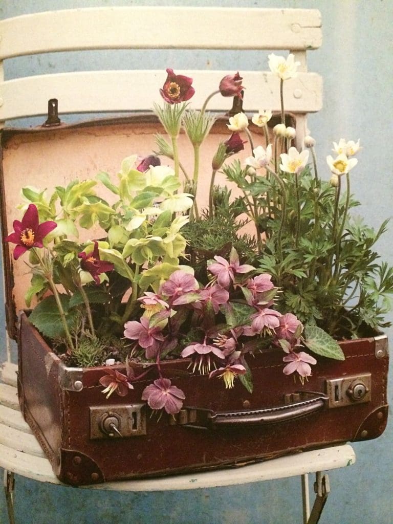 old brown vintage suitcase with pink and green flowers inside