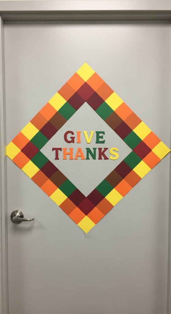 simple office thanksgiving decor made from colored paper to make a quilted pattern