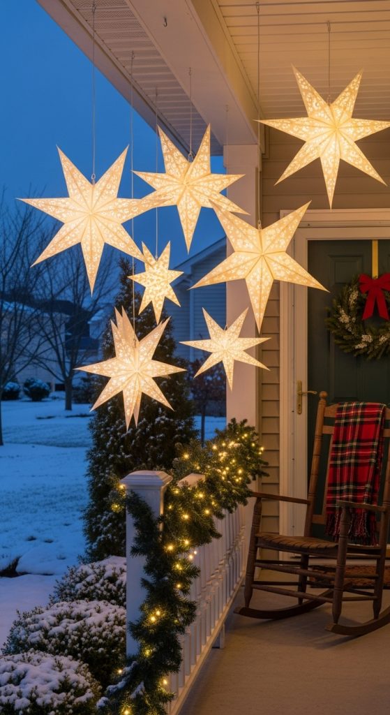simple front porch decor ideas for christmas with paper stars hanging from the porch roof.