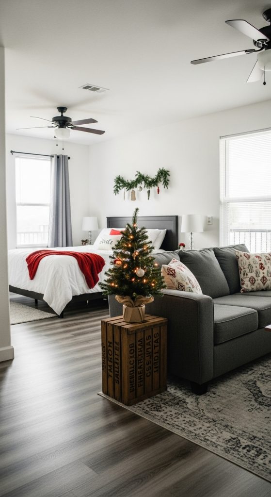 small christmas tree on a crate in a studio apartment. 