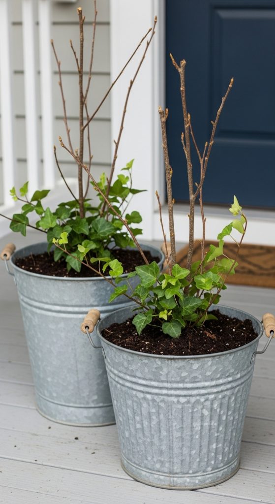 tin bucket planters with twig branches and ivy