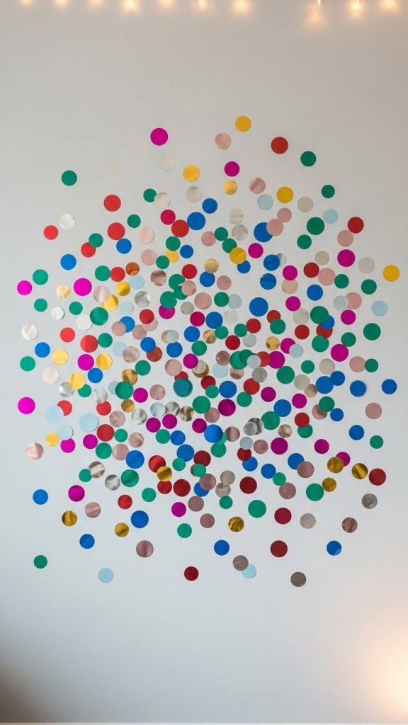 Small circles cut out and stuck to wall for New Year's photos