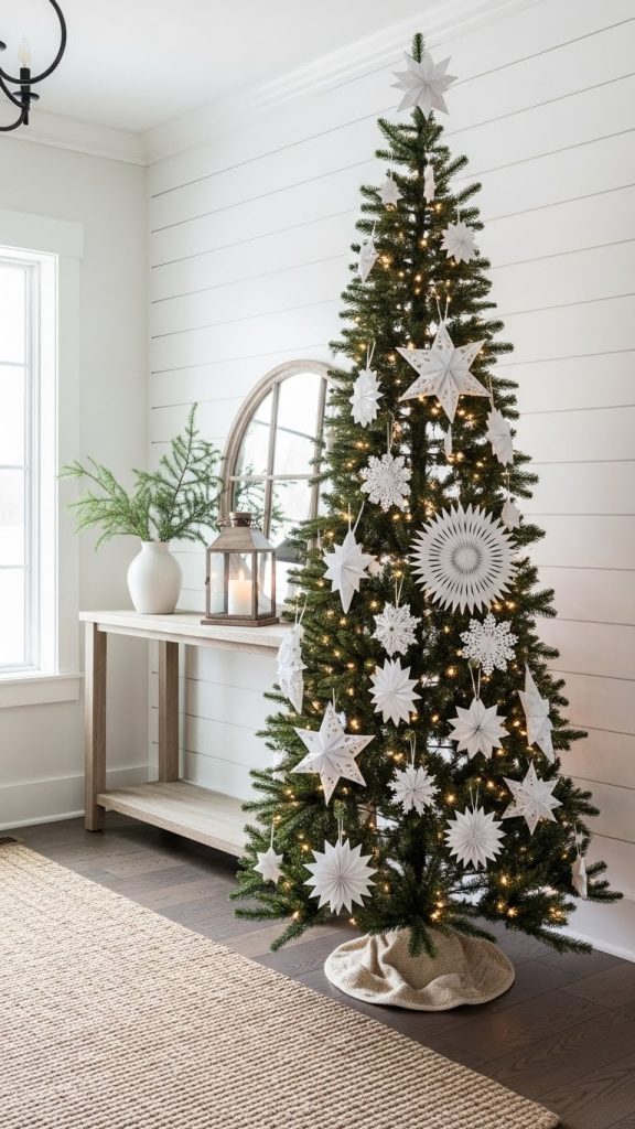 tall fir Christmas tree in entryway decorated with large paper ornaments.