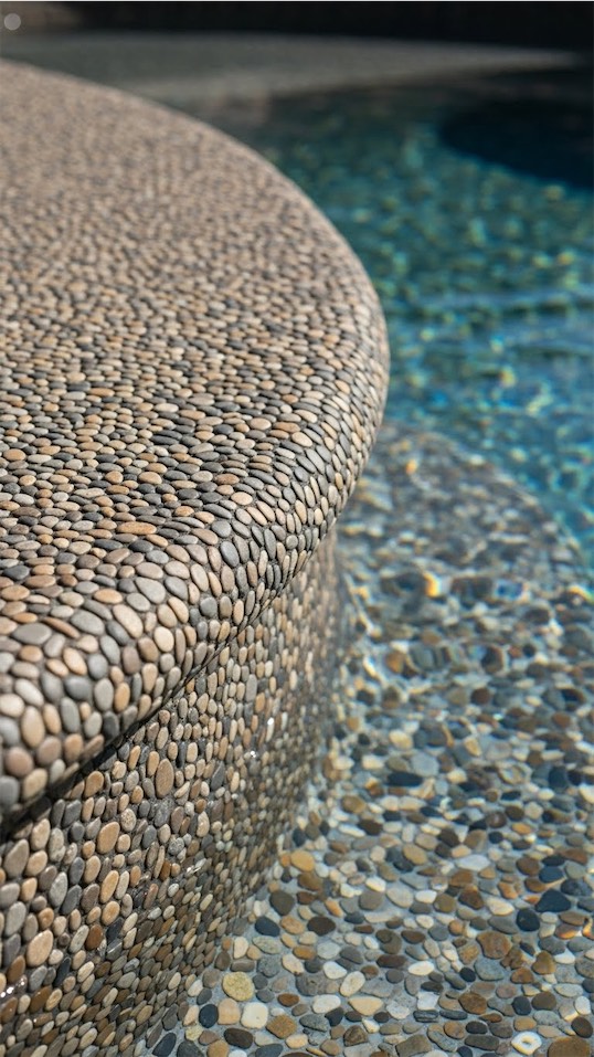 pebbles around pool edge for a cohesive look