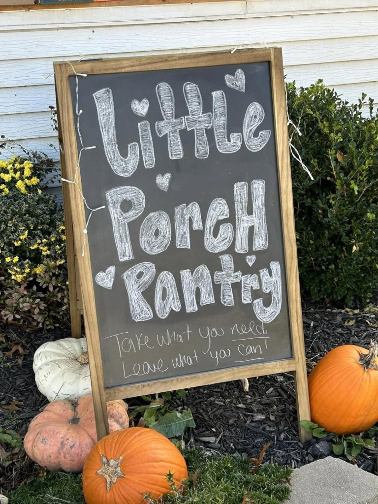 chalkboard sign with writing about a Little Free Pantry