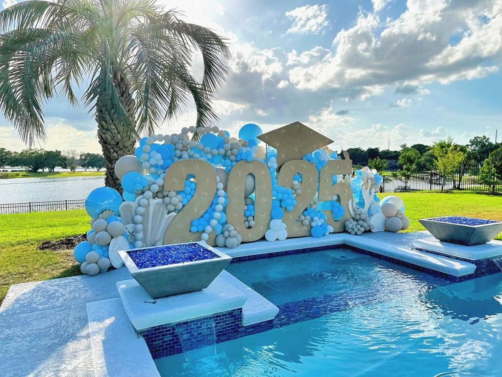 big balloon backdrop at the end of a pool for photos