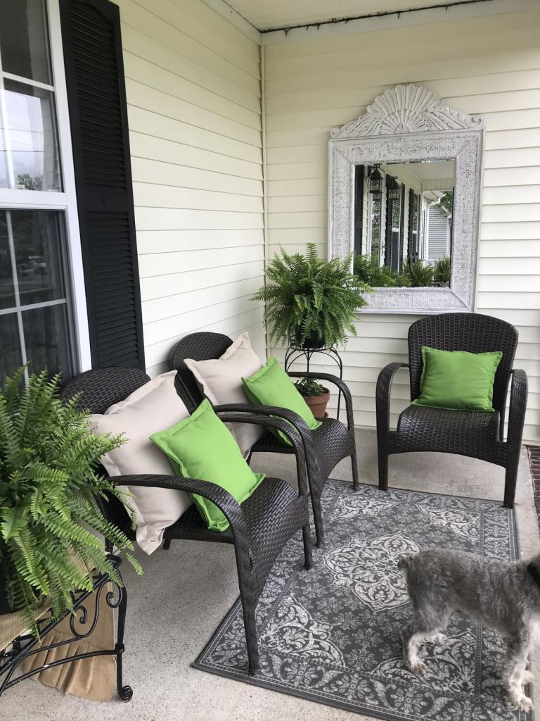 Whitewashed mirror hanging in porch